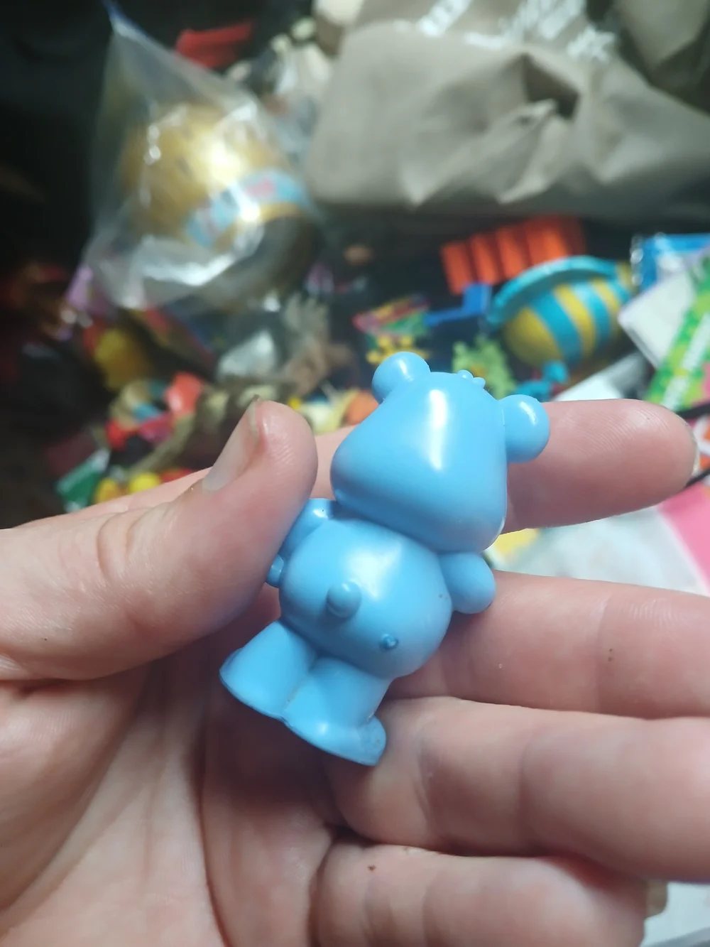 small plastic figurine of Grumpy Bear from the Care Bears franchise